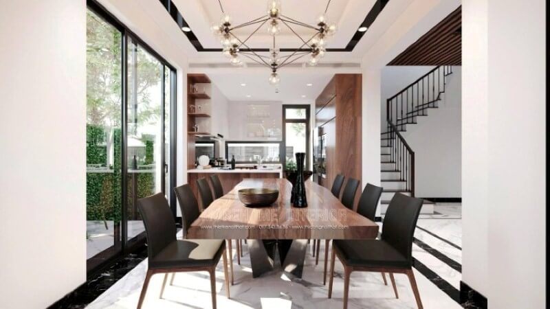 Để tạo nên vẻ đẹp tổng thể trong ý tưởng bố trí không gian phòng ăn biệt thự Vinhomes Imperia Hải Phòng, việc sử dụng và sử dụng vật liệu lát nền lại càng được chú ý. Sử dụng chút nghệ thuật sắp đặt như trong mẫu bố trí trên đây, đá lát nền được bao bọc xung quanh bởi khung viền đá đen như thể hiện ranh giới rõ ràng của phòng ăn, ngước lên trên, bạn có thể thấy nét đẹp này được thể hiện đồng bộ khi trần thạch cao được tô điểm thêm đường nét vuông vắn phối cùng đèn âm tường tạo hiệu ứng độc đáo cho không gian bếp.